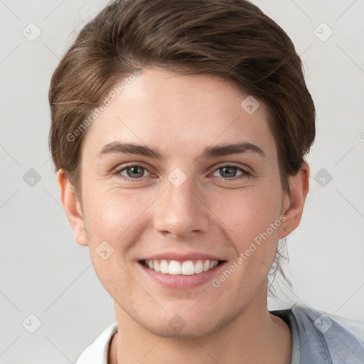 Joyful white young-adult female with short  brown hair and grey eyes