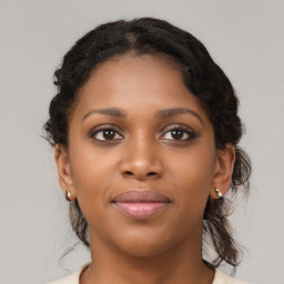 Joyful black young-adult female with short  brown hair and brown eyes