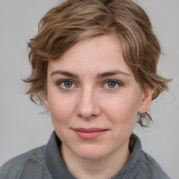 Joyful white young-adult female with medium  brown hair and blue eyes