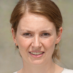 Joyful white adult female with medium  brown hair and brown eyes