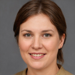 Joyful white adult female with medium  brown hair and grey eyes