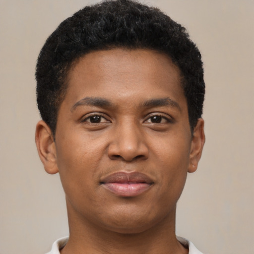 Joyful black young-adult male with short  brown hair and brown eyes