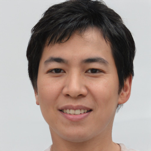 Joyful asian young-adult male with short  brown hair and brown eyes