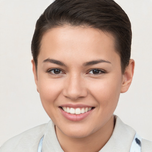 Joyful white young-adult female with short  brown hair and brown eyes