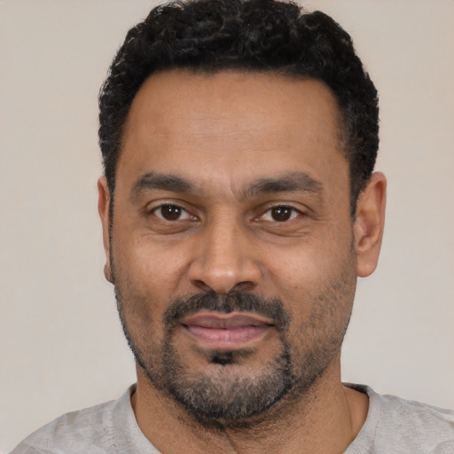 Neutral latino adult male with short  black hair and brown eyes