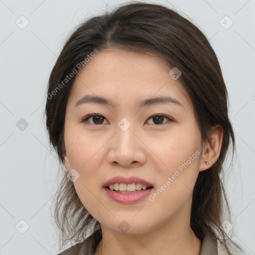 Joyful asian young-adult female with medium  brown hair and brown eyes