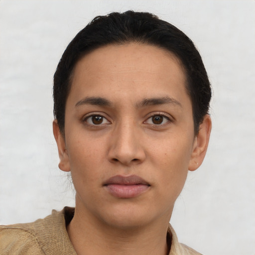 Joyful latino young-adult female with short  brown hair and brown eyes