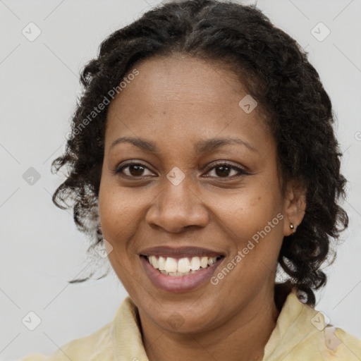 Joyful black adult female with medium  brown hair and brown eyes