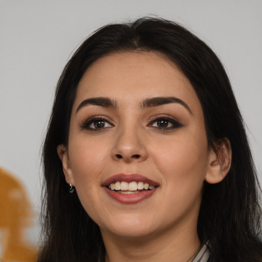 Joyful white young-adult female with long  black hair and brown eyes