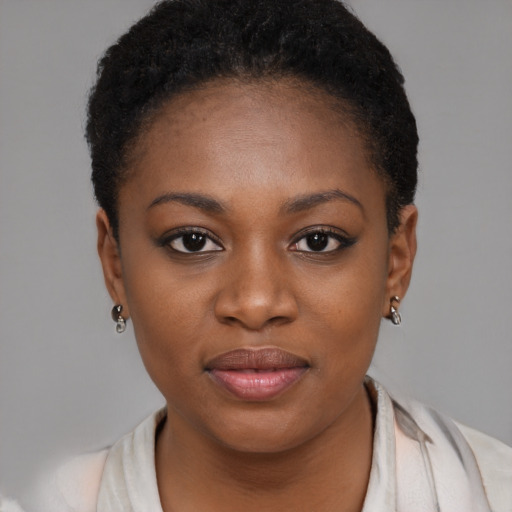 Joyful black young-adult female with short  brown hair and brown eyes