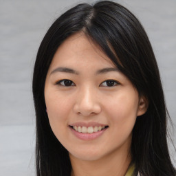 Joyful asian young-adult female with long  brown hair and brown eyes