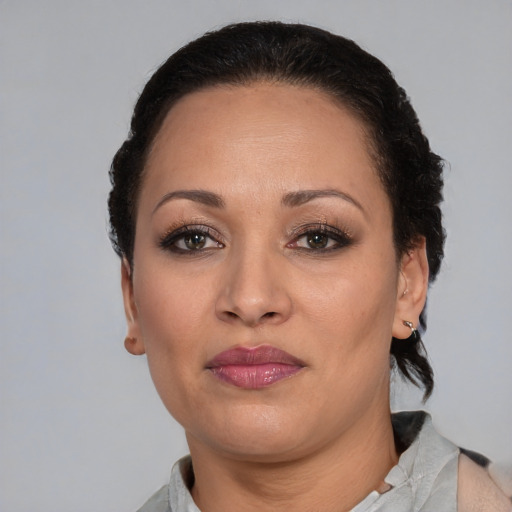 Joyful latino adult female with short  brown hair and brown eyes
