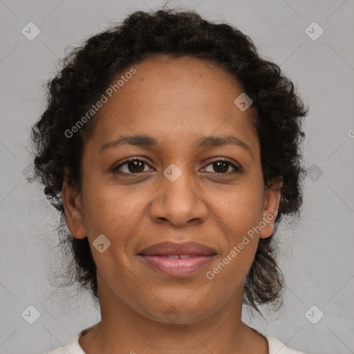 Joyful black adult female with medium  brown hair and brown eyes