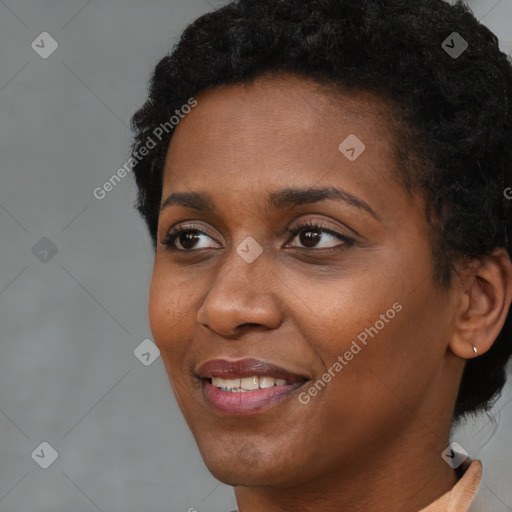 Joyful black young-adult female with short  brown hair and brown eyes