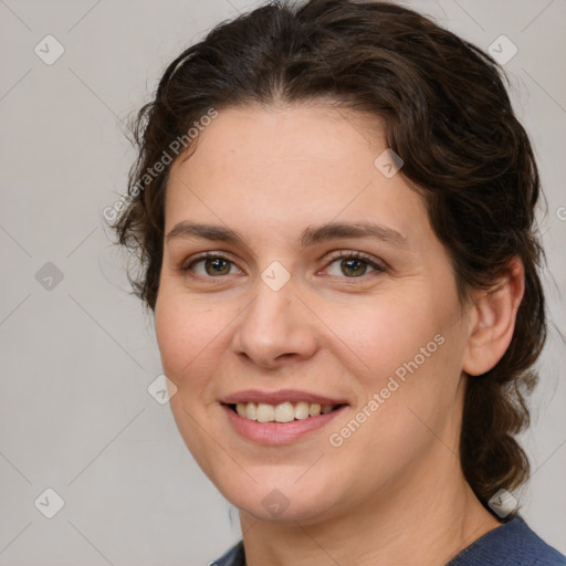 Joyful white young-adult female with medium  brown hair and grey eyes