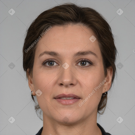 Joyful white adult female with medium  brown hair and grey eyes