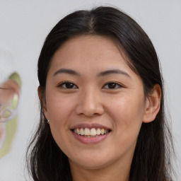 Joyful white young-adult female with long  brown hair and brown eyes