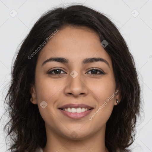 Joyful latino young-adult female with long  brown hair and brown eyes