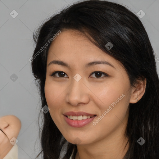 Joyful asian young-adult female with long  brown hair and brown eyes