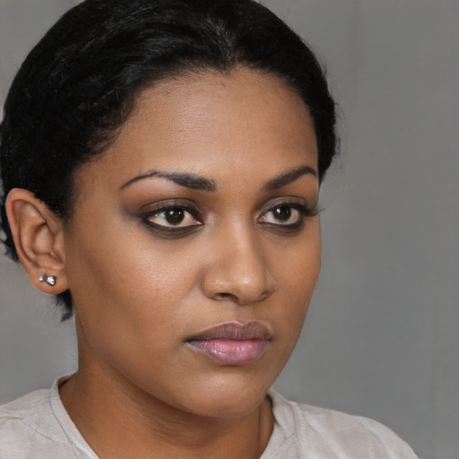 Neutral black young-adult female with medium  brown hair and brown eyes