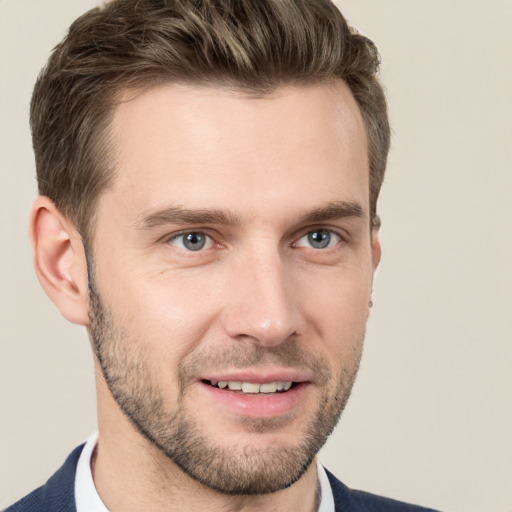 Joyful white young-adult male with short  brown hair and grey eyes