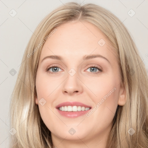 Joyful white young-adult female with long  brown hair and blue eyes