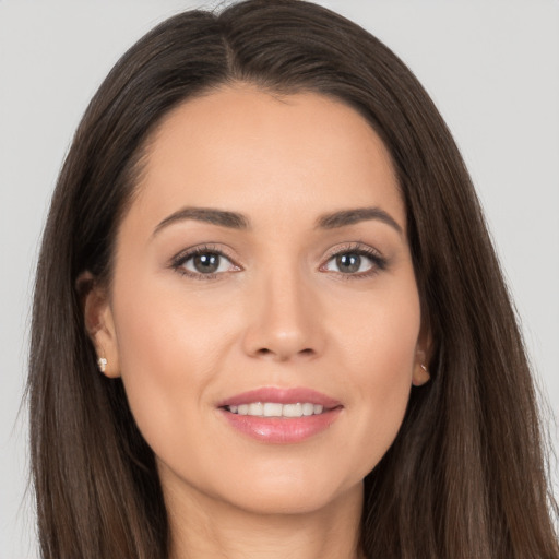 Joyful white young-adult female with long  brown hair and brown eyes