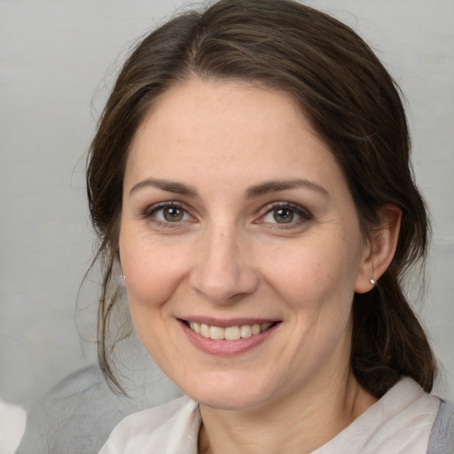 Joyful white adult female with medium  brown hair and brown eyes