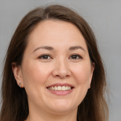 Joyful white adult female with long  brown hair and brown eyes