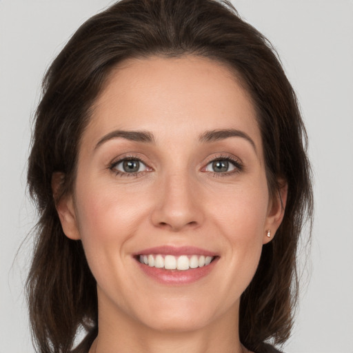 Joyful white young-adult female with medium  brown hair and brown eyes