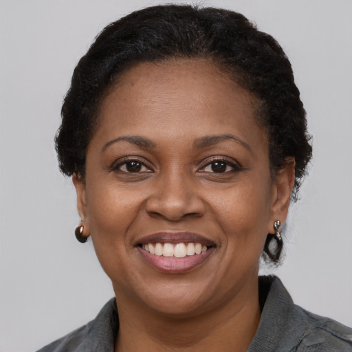 Joyful black adult female with short  brown hair and brown eyes