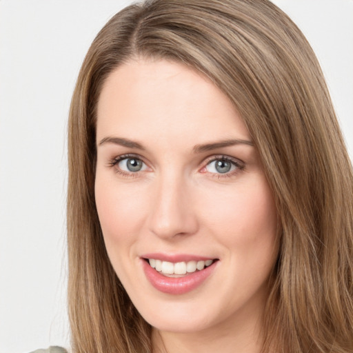 Joyful white young-adult female with long  brown hair and green eyes