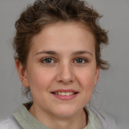 Joyful white young-adult female with medium  brown hair and blue eyes