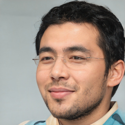 Joyful white adult male with short  black hair and brown eyes