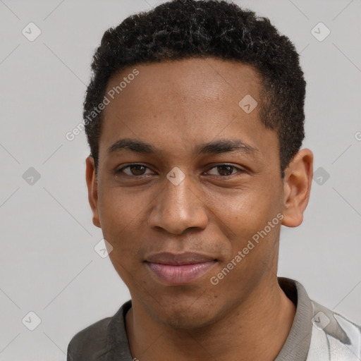 Joyful black young-adult male with short  brown hair and brown eyes