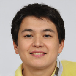 Joyful asian young-adult male with short  brown hair and brown eyes