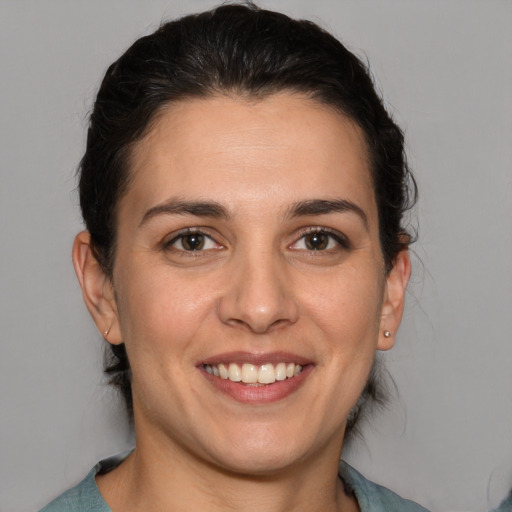 Joyful white adult female with medium  brown hair and brown eyes