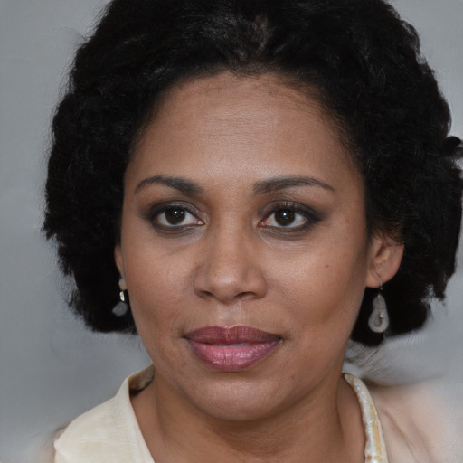 Joyful black adult female with short  brown hair and brown eyes