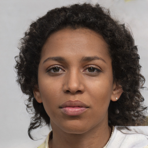 Neutral black young-adult female with medium  brown hair and brown eyes