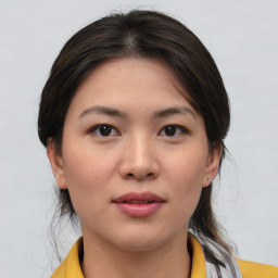 Joyful asian young-adult female with medium  brown hair and brown eyes