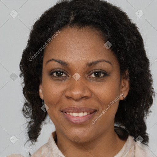 Joyful black adult female with medium  brown hair and brown eyes