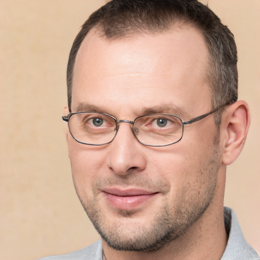 Joyful white adult male with short  brown hair and brown eyes