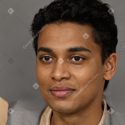 Joyful black young-adult male with short  black hair and brown eyes