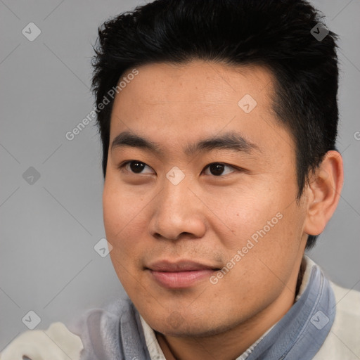 Joyful asian young-adult male with short  black hair and brown eyes