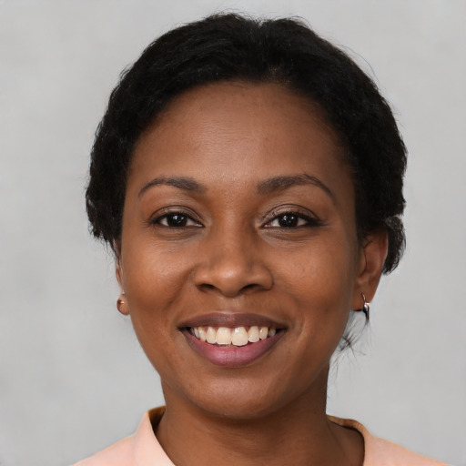 Joyful black young-adult female with medium  brown hair and brown eyes