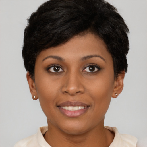 Joyful black young-adult female with short  brown hair and brown eyes