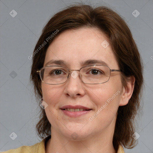 Joyful white adult female with medium  brown hair and blue eyes