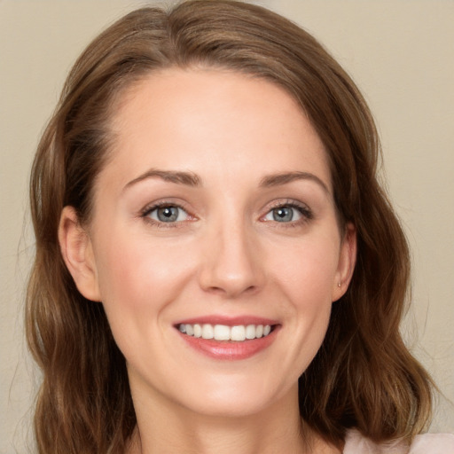 Joyful white young-adult female with long  brown hair and green eyes