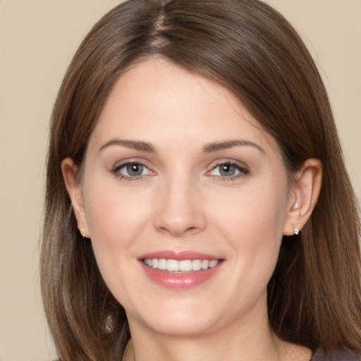 Joyful white young-adult female with long  brown hair and brown eyes