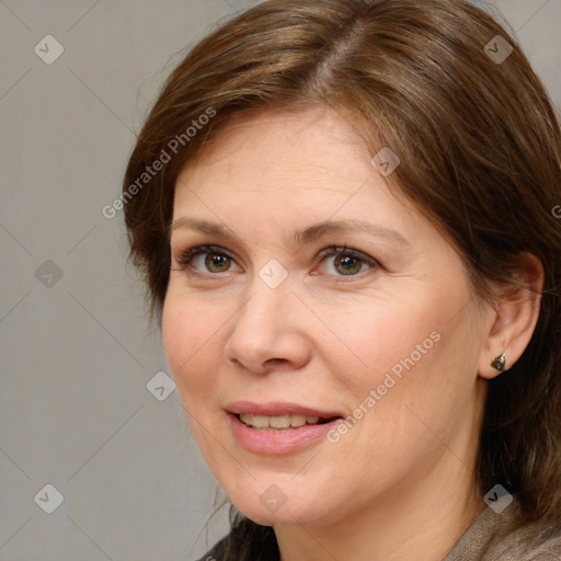 Joyful white adult female with medium  brown hair and brown eyes